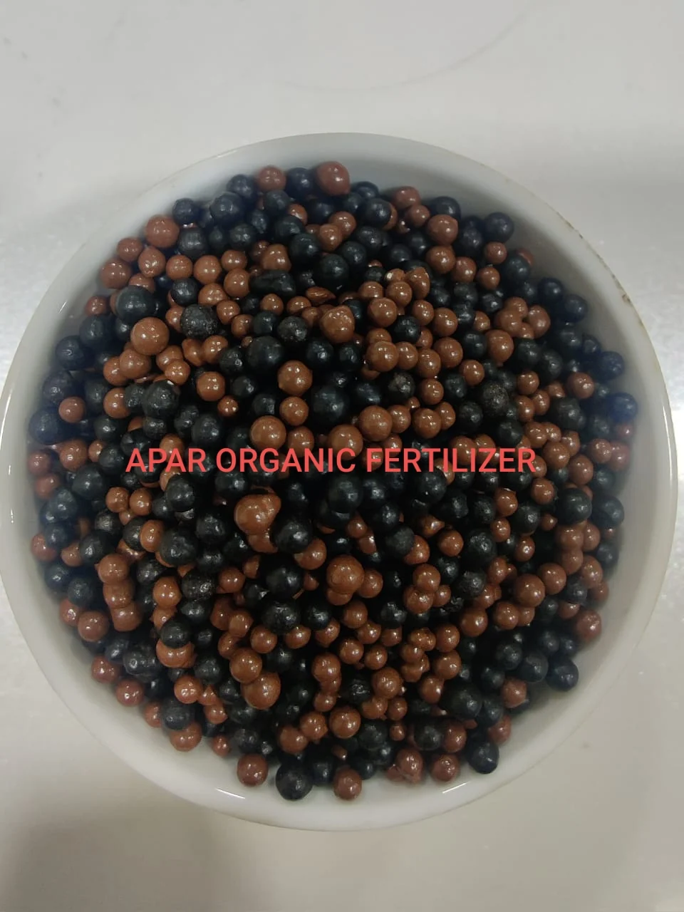 Brown and black granules in bowl